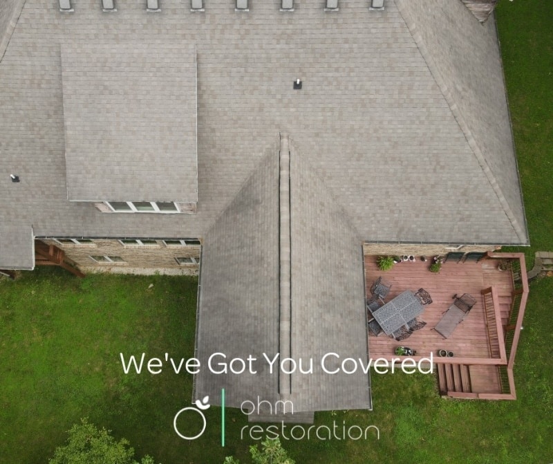 Residential home's roof overhead view while being inspected by a drone.